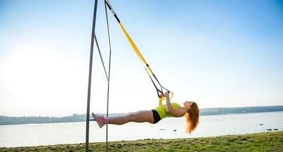 Woman Exercising With Suspension Trainer Sling